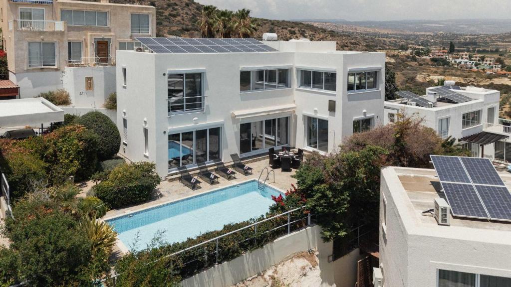 an aerial view of a house with solar panels on it at 3BR Panoramic Sea View Villa with Private Pool by Cyprus Horizons in Pissouri