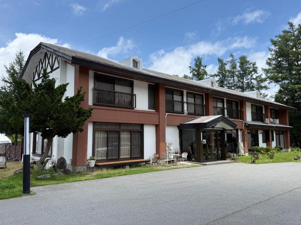a large red and white building with a lot of windows at Yamanaka Lake Ryozan in Yamanakako