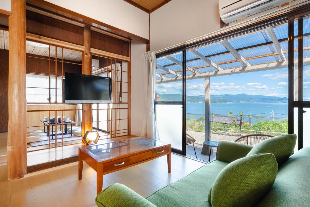 a living room with a view of the ocean at Azure Kawatana in Mitsugoe
