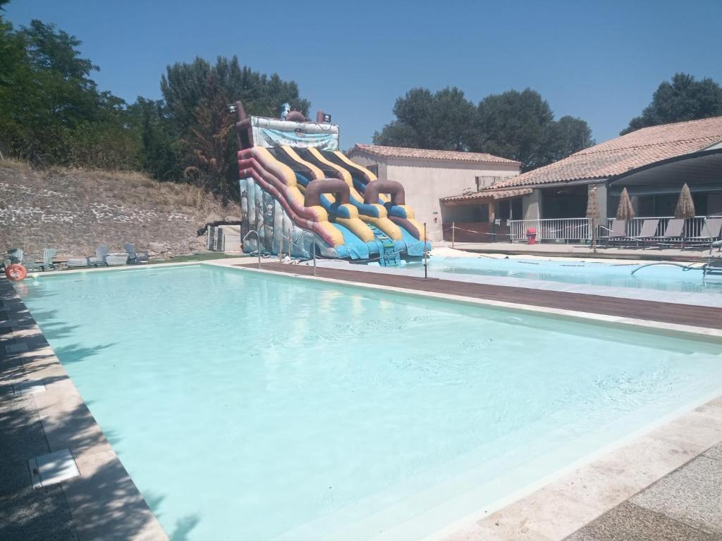 a swimming pool with a bunch of inflatables at Camping Mas Sud Ardèche in Saint-Just