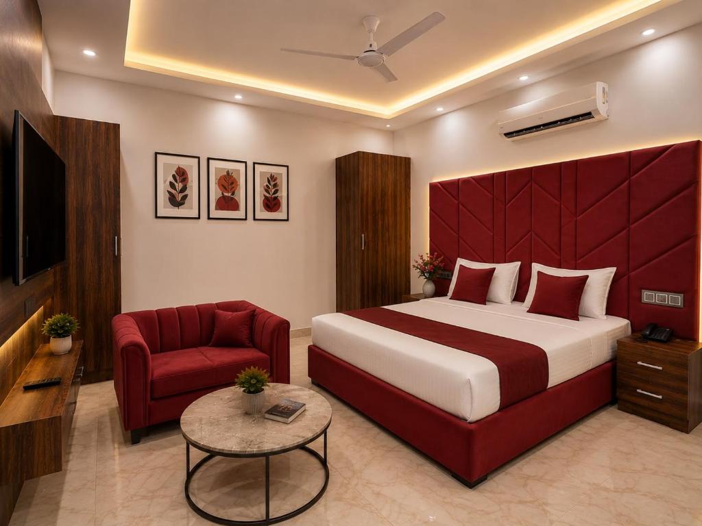 a hotel room with a large bed and a chair at Hotel Amar Raja in Kurukshetra