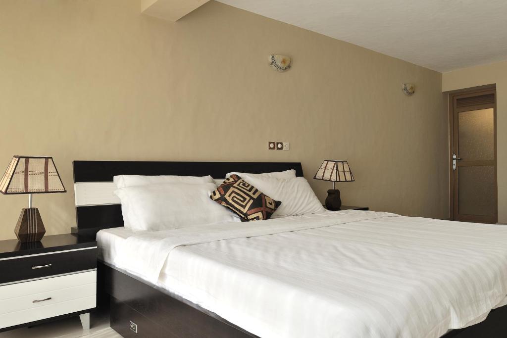 Postel nebo postele na pokoji v ubytování Hotel Safari Gate