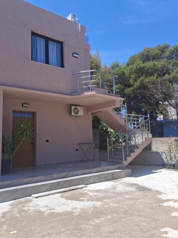 a house with a staircase leading up to a building at Vila Familjare Vlore in Vlorë