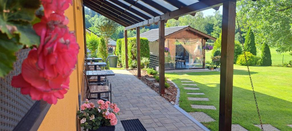 a patio with benches and a gazebo at Penzion V Hájku in Vřesina