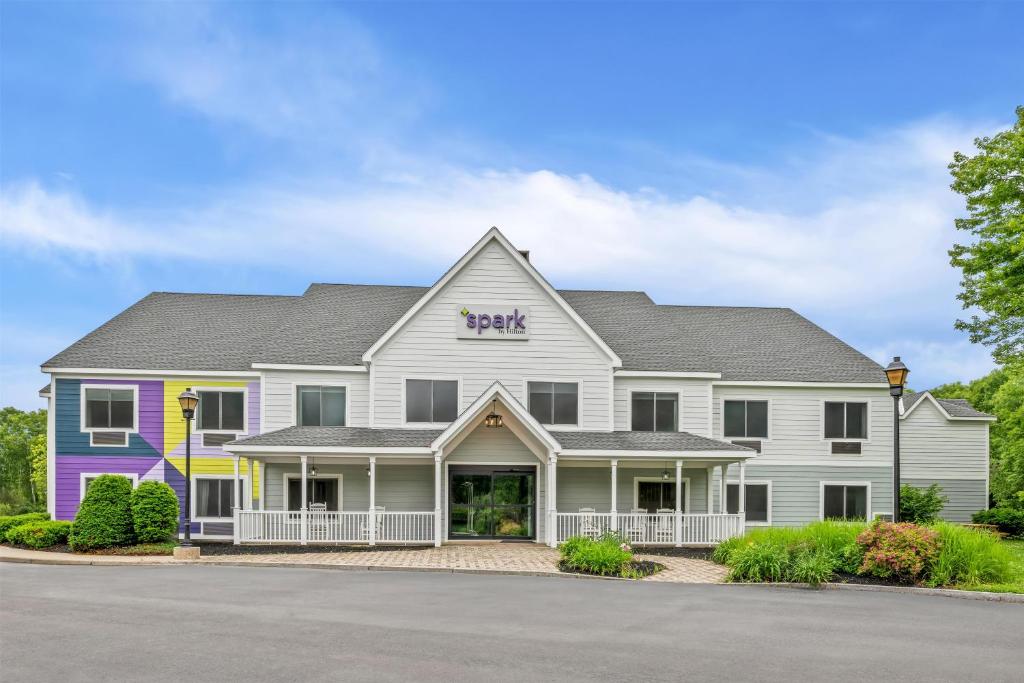 a large white building with a sign on it at Spark by Hilton Brunswick in Brunswick