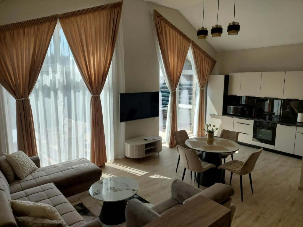a living room with a couch and a table at Sweet villa Palanga in Palanga
