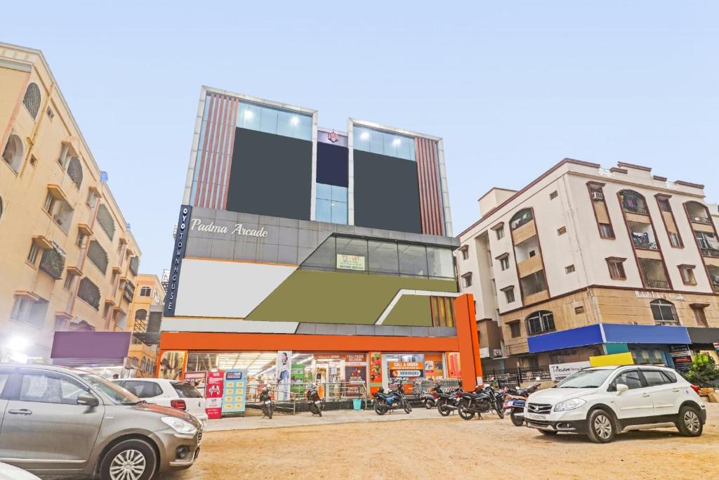 a street with cars parked in front of a building at Super Hotel O THE FERN SUITES in Hyderabad