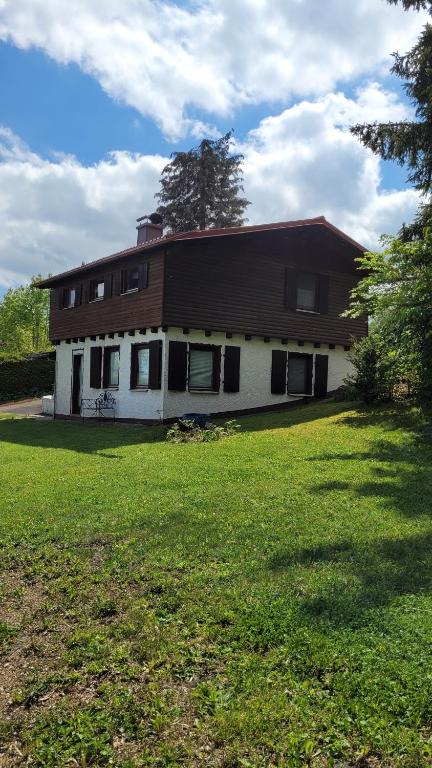 a house with a large yard in front of it at Ferienhaus Bambach in Fladungen