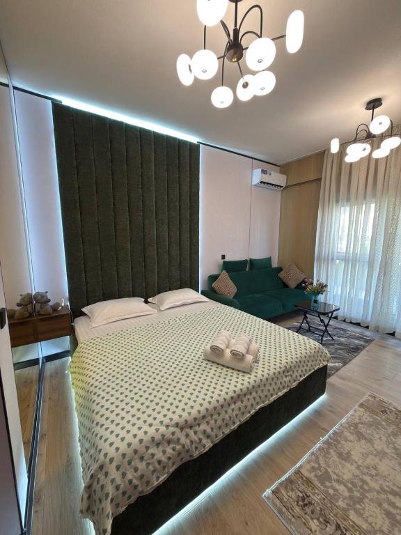 a bedroom with a large bed and a couch at Чарвак Дарвозаси in Chorwoq