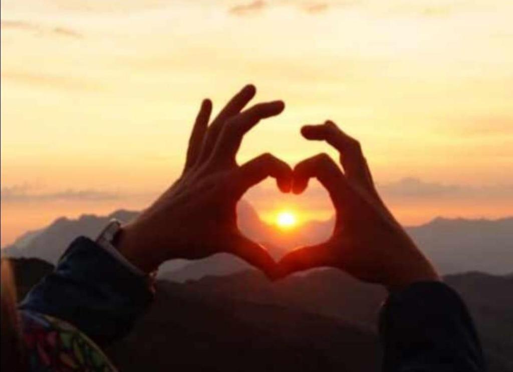 a person making a heart shape with their hands at Obernberg in Aurach bei Kitzbuhel