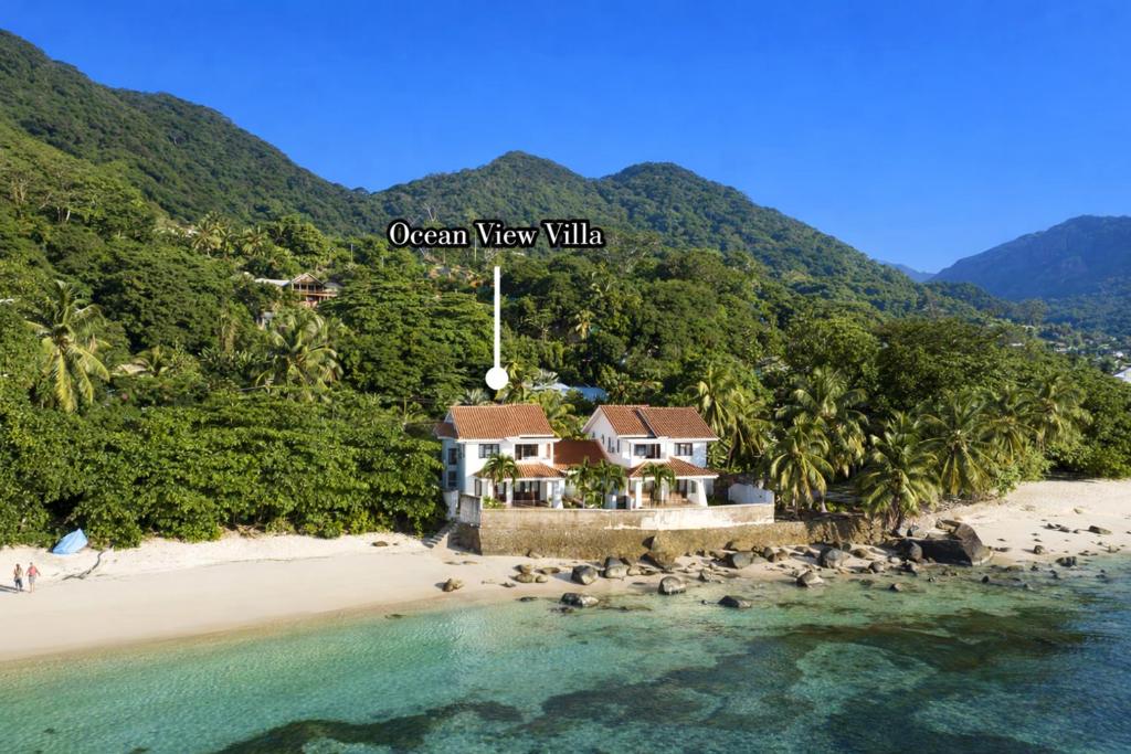 a house on a beach with the words ocean view villa at Ocean View Villa - Beauvallon villas in Beau Vallon