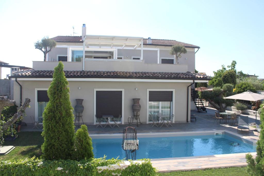 a villa with a swimming pool in front of a house at Corte Lissa in Termoli