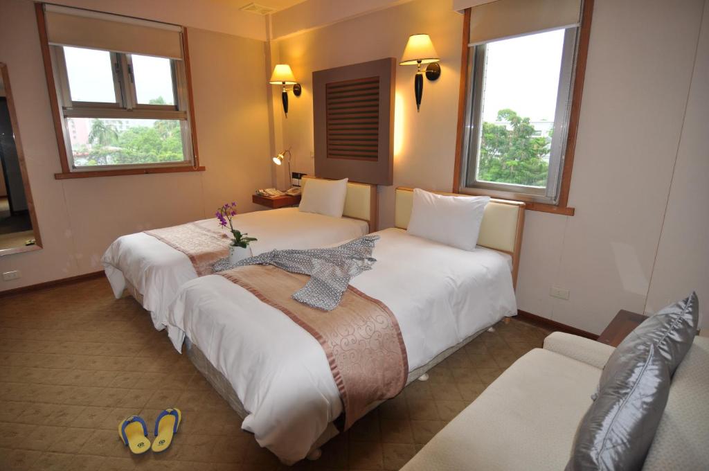 Postel nebo postele na pokoji v ubytování Tian Long Hotel