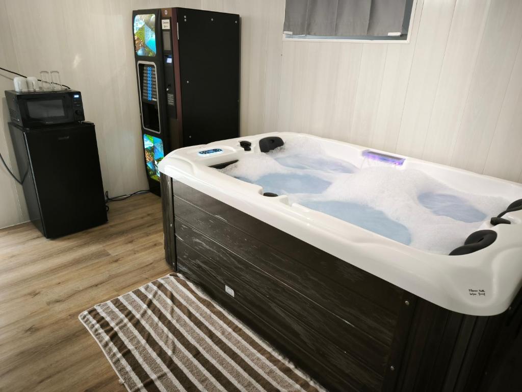 a large bath tub in a room with a television at Suite DT4 in Blotzheim