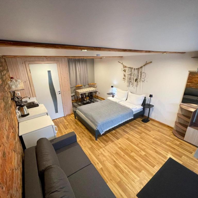 a bedroom with a bed and a couch in a room at Pāvilostas Piparmētras in Pāvilosta