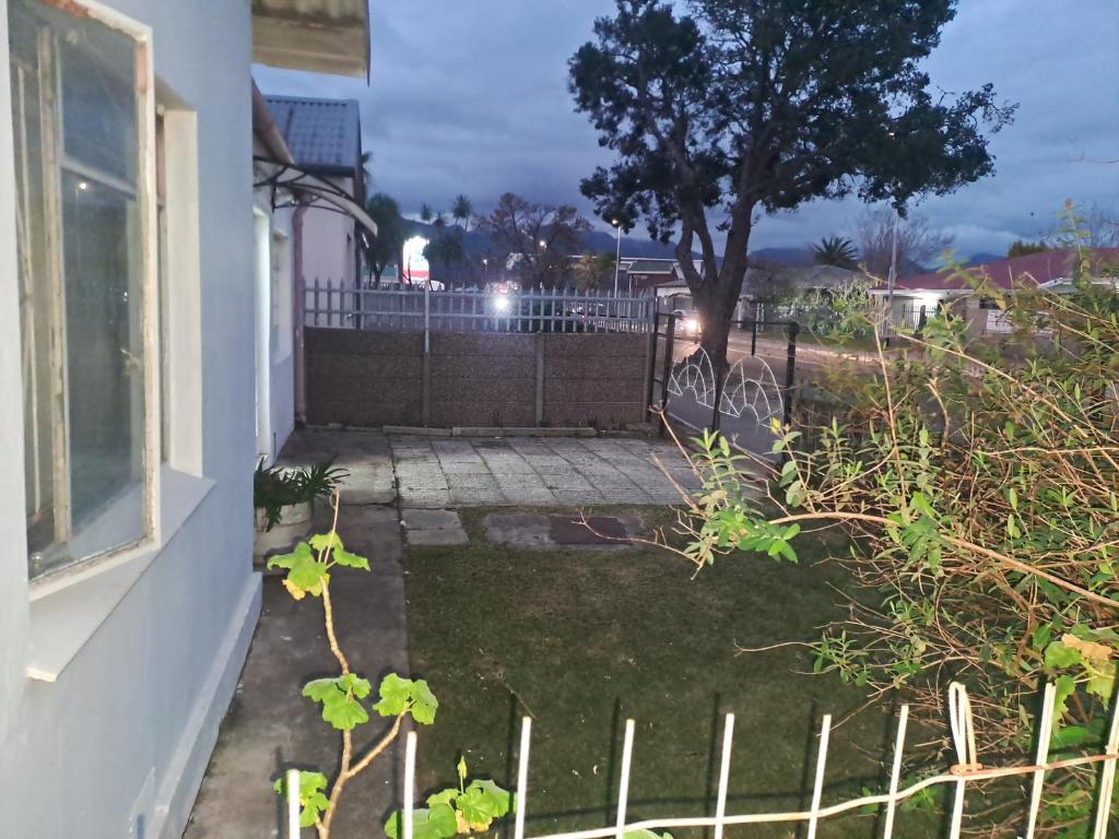 a view of a yard with a fence and a tree at The haven in George