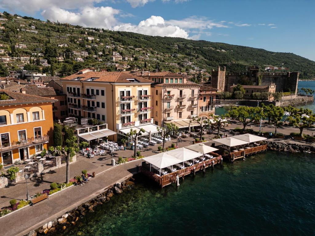 an aerial view of a town next to a body of water at Hotel Del Porto in Torri del Benaco