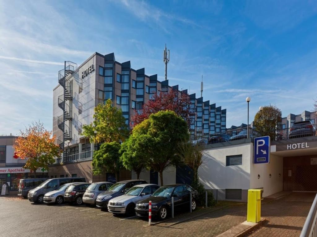 a row of cars parked in front of a hotel at Sunday Hotel Köln Brühl in Brühl