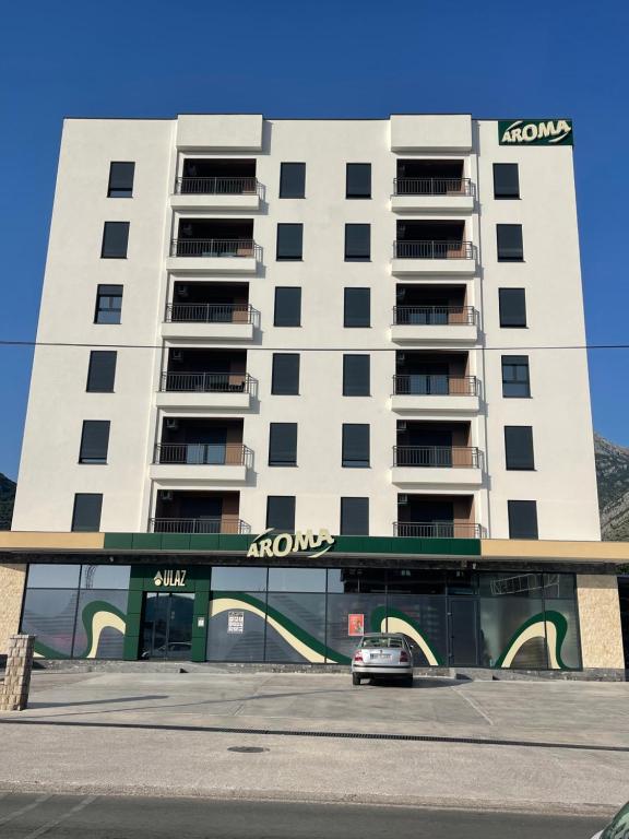 a car parked in front of a building at Apartmani B&A in Ulcinj