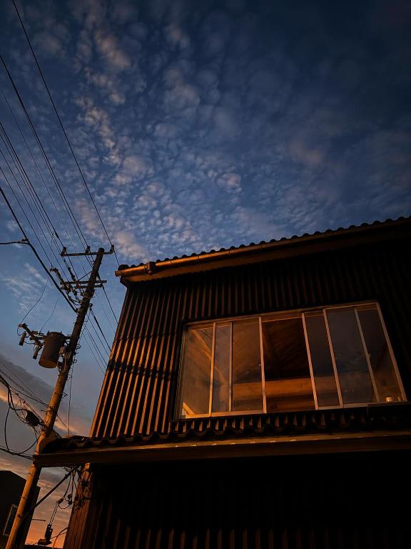 a building with a window on the side of it at HOTEl MOTO in Oshima