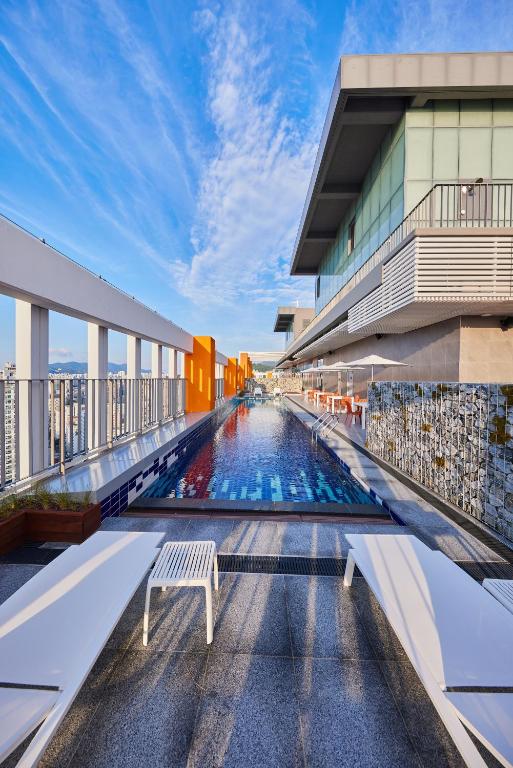 a swimming pool on the roof of a building at Hotel HLB in Busan