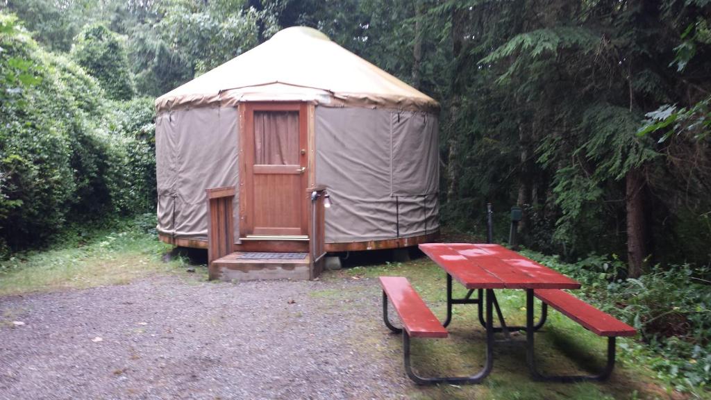 a yurt with a picnic table and a bench at Snowflower Camping Resort 16 ft. Yurt 10 in Emigrant Gap