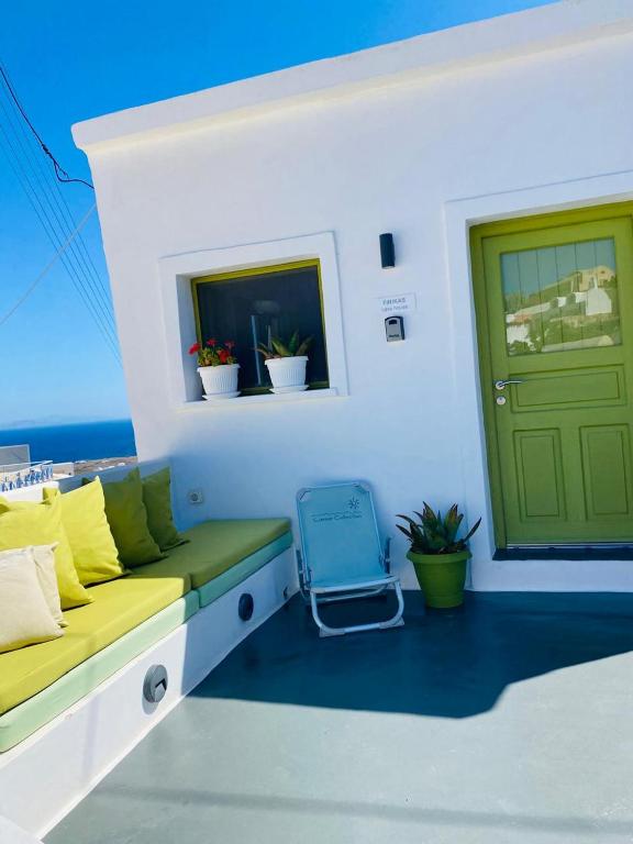 a bench on a balcony with a door and a window at Finikas Cave House in Foinikiá