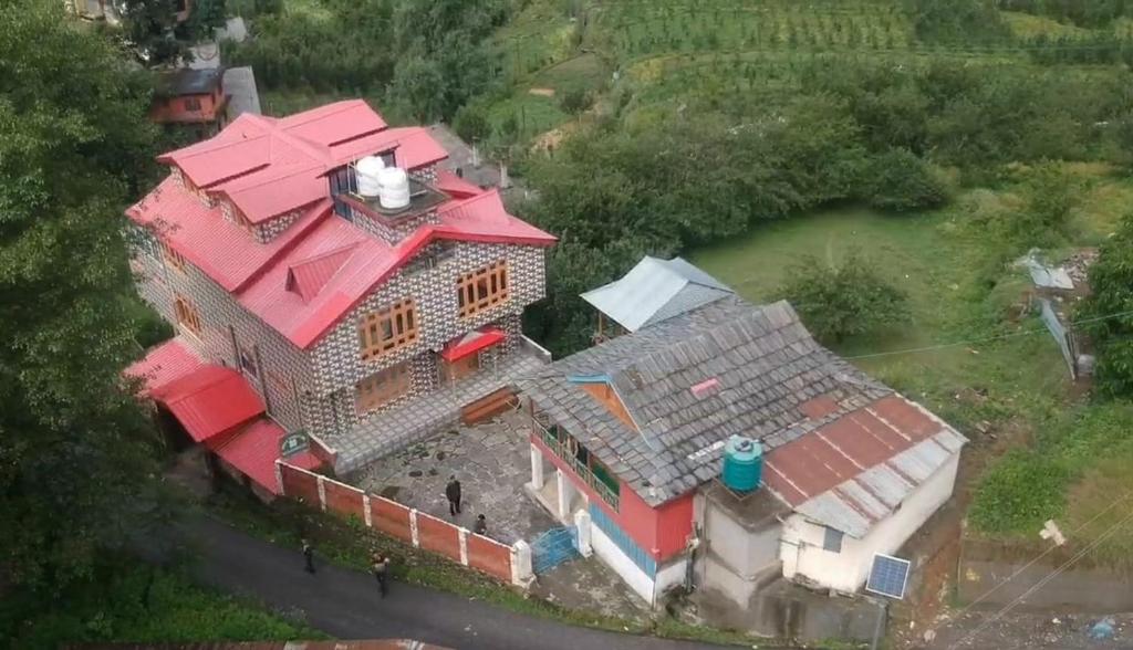an overhead view of a large house with red roofs at DELTA Inn HOMESTAY in Khashdhār