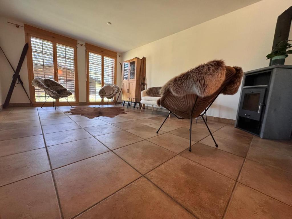 a living room with a couch and a fireplace at Tgèsa Staziun in Sedrun