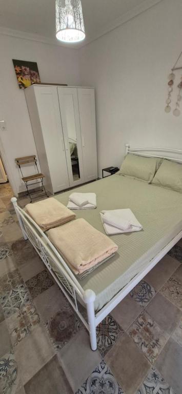 a bed with two towels on it in a room at Sea home Asprovalta in Asprovalta