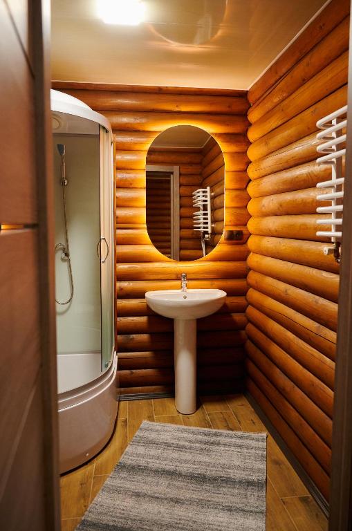 a bathroom with a sink and a mirror at Готель Кумир in Rivne