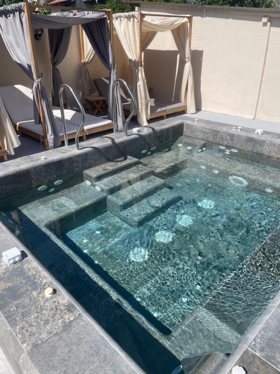 a pool of water with a table and chairs in it at Family Hotel Malibu in Chernomorets