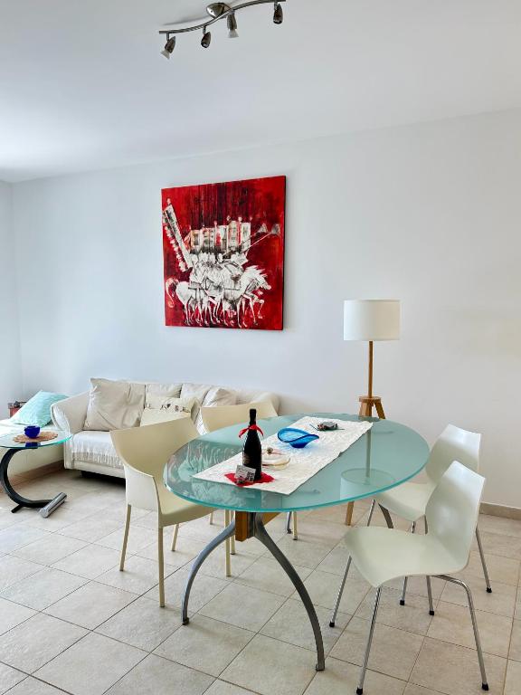 a living room with a glass table and a couch at Vista Dourada in Porto Santo