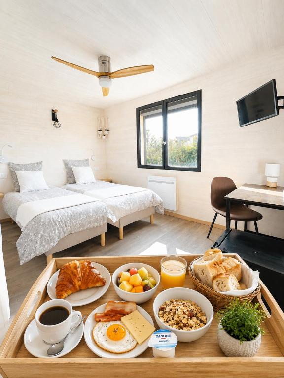 a tray of breakfast food on a table in a room at L'Océane Bed&Breakfast in Lacanau-Océan
