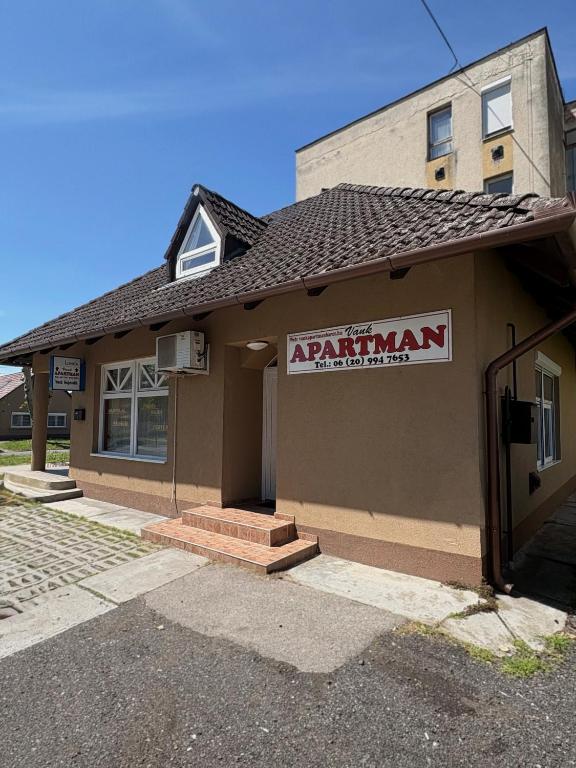 a building with a sign on the front of it at Vank Apartman Barcs in Barcs