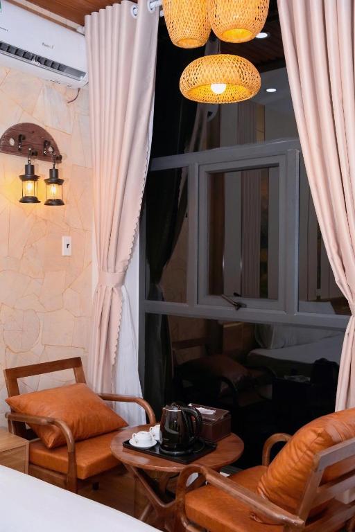 a room with a table and a chair and a window at Thong Dong homestay&villas in Ninh Binh