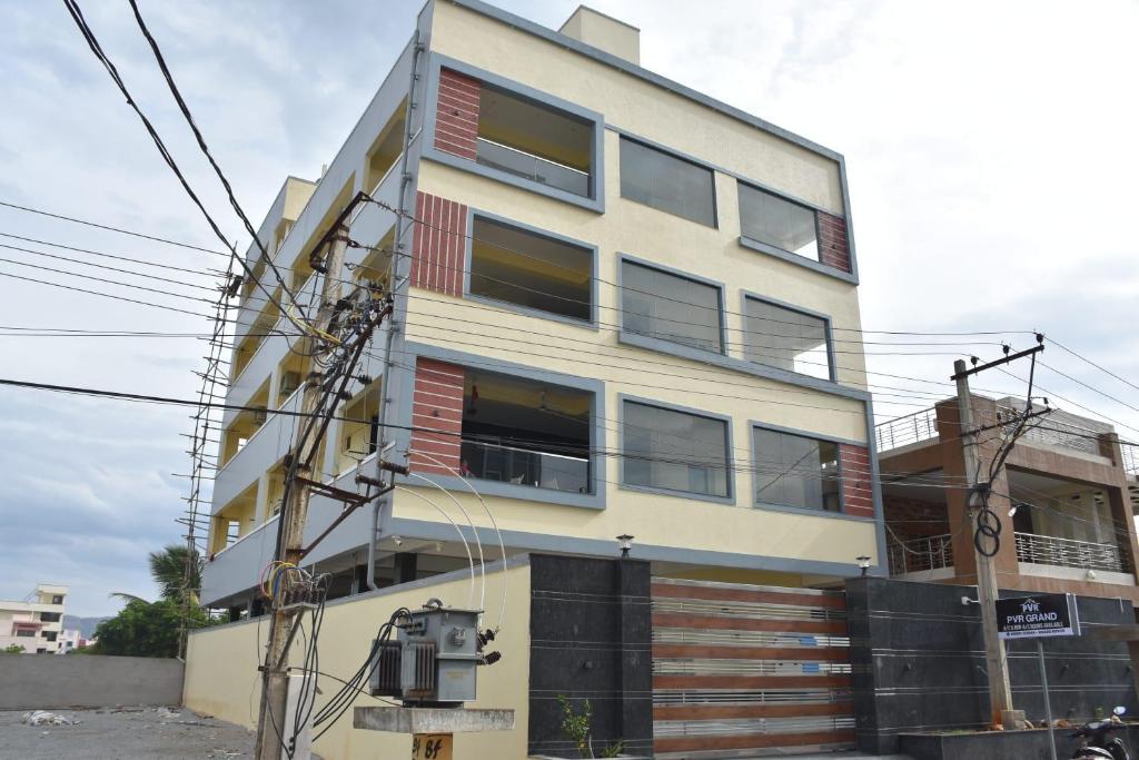 a tall white building with many windows at PVR Grand in Tirupati