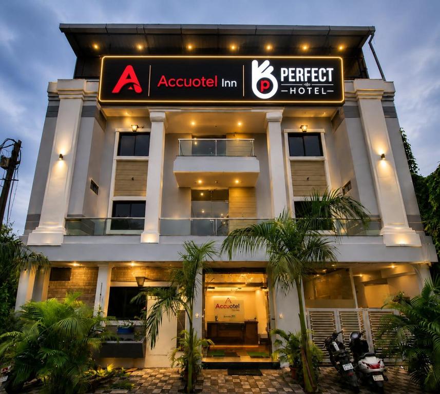 a perfect hotel with a sign in front of it at Accuotel Hotel Perfect in Indore