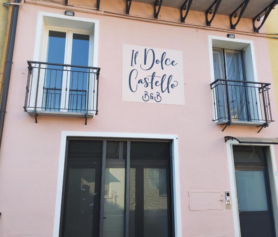 a pink building with a sign that reads it diabetes castle at B&B Il Dolce Castello di Balestrino in Balestrino
