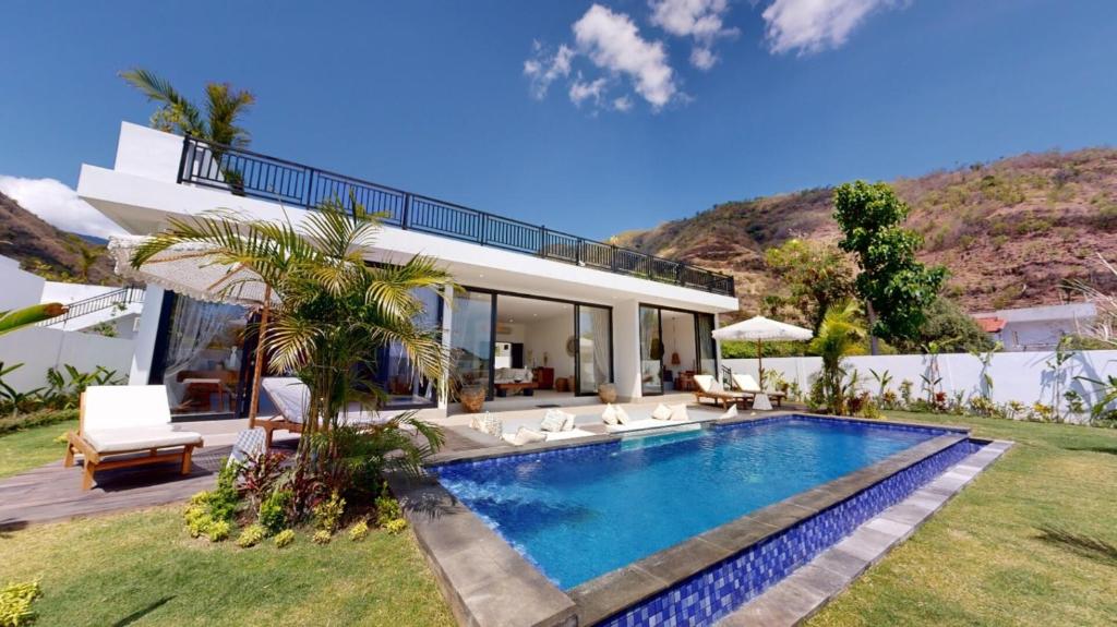 a house with a swimming pool in the yard at Villa Mercure. Private villa. 2 en-suite bedrooms. in Amed