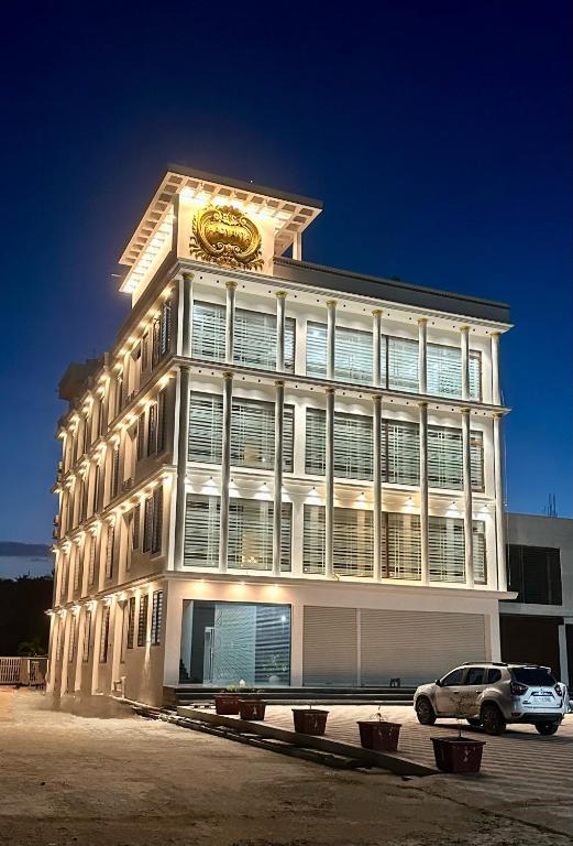 a building with a clock on the top of it at Aadyanta in Kadūr