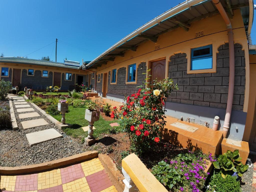 a house with flowers in front of it at JC ITEN Guest House in Iten