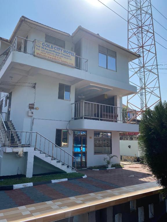 a white building with a sign on it at New Gold city hotel in Mwanza
