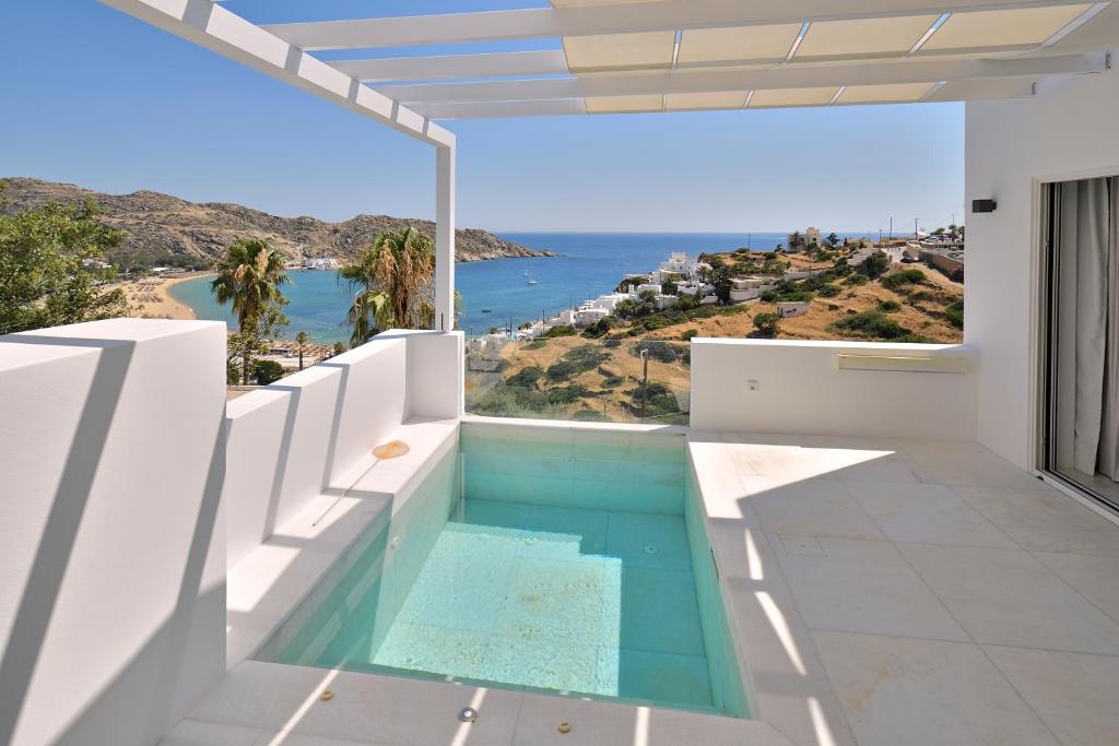 a swimming pool in a house with a view of the ocean at Theros Apartments 3 in Mylopotas
