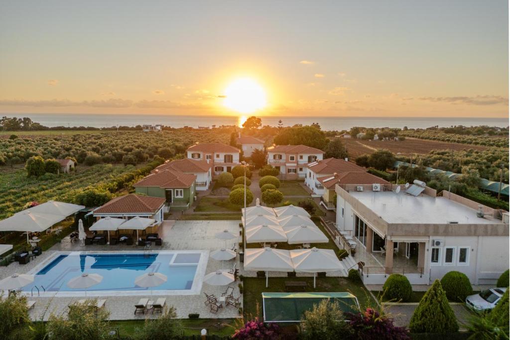 an aerial view of a mansion with the sunset in the background at Stomio Villague in Filiatra