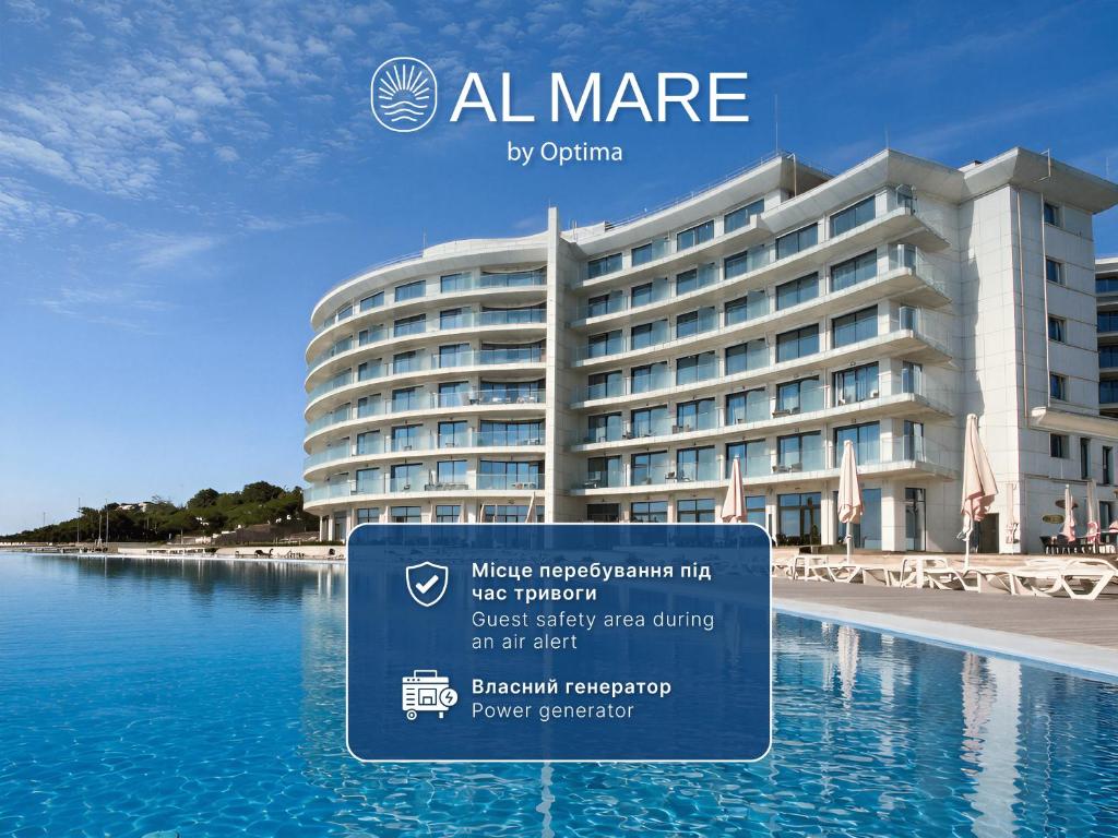 a hotel with a sign in front of a body of water at Al Mare by Optima in Chornomorsk