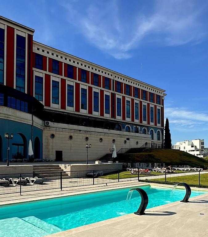 a building with a swimming pool in front of a building at Villa Augusta Spa & Garden in Valladolid