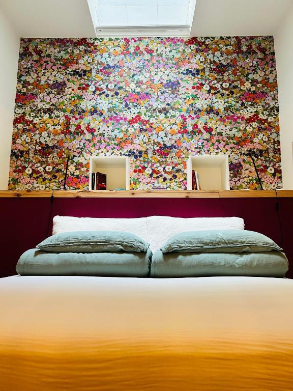 a bedroom with a large painting on the wall at Chez Gaston in Spa