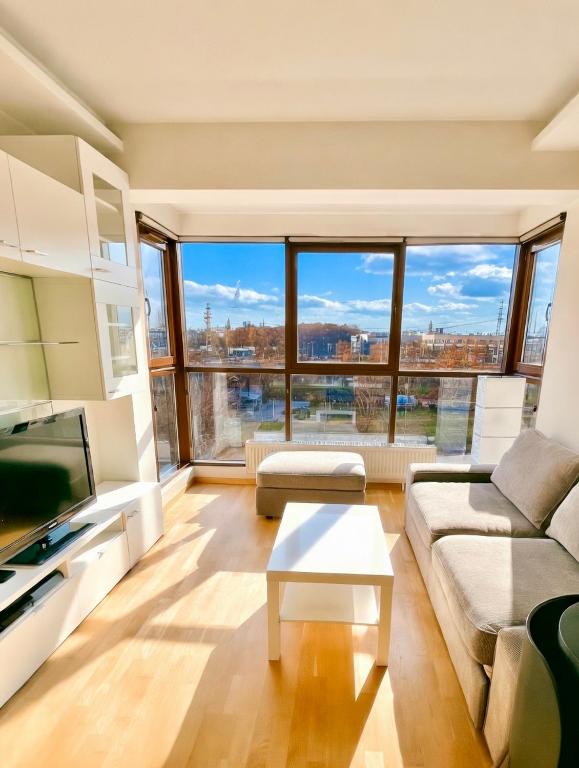a living room with a couch and a table at No̱410 City View Apartment & free parking in Krakow