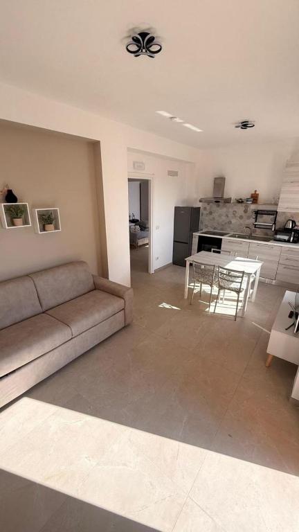 a living room with a couch and a table at Dimora Zaffiro in LʼAquila